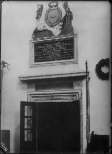 Klewań, Kości&oacute;ł p.w. Zwiastowania Najświętszej Maryi Panny - portal w prezbiterium z wmontowaną nad nim tablicą erekcyjną kościoła zwieńczoną polichromią z medalionem w kt&oacute;rym p&oacute;łksiężyc